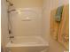 Clean, white bathroom with tub-shower combination and floral-themed towels at 962 Henry James Dr., Myrtle Beach, SC 29579