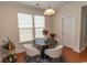 Inviting dining area with a modern round table set, bathed in natural light from large windows at 962 Henry James Dr., Myrtle Beach, SC 29579