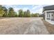 The spacious backyard is mostly unfinished and lined with mature trees at 1052 Merritt Rd, Conway, SC 29526