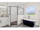 Beautiful bathroom featuring a stand alone tub, glass shower, granite counters and white cabinets at 1052 Merritt Rd, Conway, SC 29526