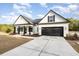 Beautiful white farmhouse with a concrete driveway and black accents on a sunny day at 1052 Merritt Rd, Conway, SC 29526