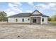Rear exterior of a modern single-Gathering home with a covered patio and gray roof at 1052 Merritt Rd, Conway, SC 29526