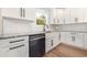 Close up of the kitchen with granite counters, white cabinets, stainless steel appliances, and a farmhouse sink at 1052 Merritt Rd, Conway, SC 29526