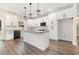 Bright kitchen with white cabinets, granite countertops, island, and modern lighting fixtures at 1052 Merritt Rd, Conway, SC 29526