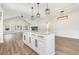 Open concept kitchen with large island, granite countertops, pendant lighting and view of fireplace in living room at 1052 Merritt Rd, Conway, SC 29526