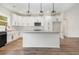 Bright kitchen with white cabinets, granite countertops, stainless appliances and attractive pendant lighting at 1052 Merritt Rd, Conway, SC 29526