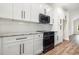 Modern kitchen featuring black stainless appliances, white cabinets, granite counters and stylish backsplash at 1052 Merritt Rd, Conway, SC 29526