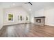 Bright and airy living room with a vaulted ceiling, fireplace, and wood-look floors at 1052 Merritt Rd, Conway, SC 29526