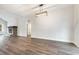 Spacious living room with wood floors, fireplace with a brick hearth, modern light fixture, and large windows at 1052 Merritt Rd, Conway, SC 29526