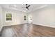 Large main bedroom with wood floors, trey ceilings, a ceiling fan and large windows overlooking the backyard at 1052 Merritt Rd, Conway, SC 29526