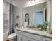 Bathroom featuring granite countertop, framed mirror, and a shower with stylish gray curtains at 108 Wagner Cir., Conway, SC 29526