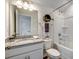 Well-lit bathroom with a granite countertop vanity, mirror, and a bathtub with a shower at 108 Wagner Cir., Conway, SC 29526