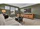 Cozy living room with a TV, a modern entertainment center, and three bright, natural-lit windows at 108 Wagner Cir., Conway, SC 29526