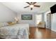 Large bedroom with hardwood floors, ceiling fan, and large wall art at 115 Blue Pride Dr., Loris, SC 29569