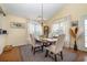 Bright dining room area with hardwood floors, a chandelier, and a view to the fenced-in yard at 115 Blue Pride Dr., Loris, SC 29569