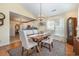 Elegant dining room features a rustic table, chandelier, and views into the modern kitchen at 115 Blue Pride Dr., Loris, SC 29569