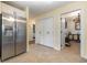 Hallway featuring a stainless steel refrigerator, tile flooring, and white walls at 115 Blue Pride Dr., Loris, SC 29569