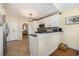 Well-lit kitchen with white cabinets, black countertops, and stainless steel appliances at 115 Blue Pride Dr., Loris, SC 29569