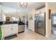 Bright kitchen with stainless steel refrigerator, tiled floors, and white cabinets at 115 Blue Pride Dr., Loris, SC 29569