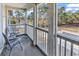 Balcony with chairs overlooking the yard with mature trees and a community pool view at 1230 St. George Ln. # F, Myrtle Beach, SC 29588