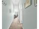 Hallway featuring light blue walls leading into the living room with coastal decor at 1230 St. George Ln. # F, Myrtle Beach, SC 29588