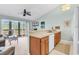 Open concept kitchen with breakfast bar and appliances overlooking the living area at 1230 St. George Ln. # F, Myrtle Beach, SC 29588