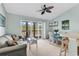 Cozy living room with sliding glass doors to balcony, comfortable seating, and dining area at 1230 St. George Ln. # F, Myrtle Beach, SC 29588