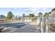 Covered community pool surrounded by a fence, with nearby parking and building in the background at 1230 St. George Ln. # F, Myrtle Beach, SC 29588