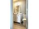 Bathroom showcases a vanity with white cabinets, a mirror, and a toilet at 140 Spanish Oak Ct. # 1, Surfside Beach, SC 29575