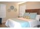 Bedroom with a bed, wooden headboard, shutters, and decorative bedside lamps at 140 Spanish Oak Ct. # 1, Surfside Beach, SC 29575