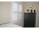 Bedroom with a dark wooden dresser, plantation shutters, and stylish décor at 140 Spanish Oak Ct. # 1, Surfside Beach, SC 29575