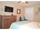 Bedroom with a bed, dark wood dresser, lounger, and shutters at 140 Spanish Oak Ct. # 1, Surfside Beach, SC 29575