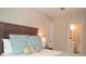 Comfortable bedroom with a wood headboard and stylish blue pillows, next to the bathroom at 140 Spanish Oak Ct. # 1, Surfside Beach, SC 29575
