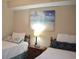 Comfortable bedroom with two twin beds, beach-themed artwork, and a cozy atmosphere at 140 Spanish Oak Ct. # 1, Surfside Beach, SC 29575