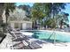 Well-maintained community pool with lounge chairs, with a restroom building in the background at 140 Spanish Oak Ct. # 1, Surfside Beach, SC 29575