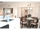 Bright dining area features a glass top table and flows into the kitchen and living spaces at 140 Spanish Oak Ct. # 1, Surfside Beach, SC 29575