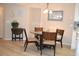 Cozy dining area featuring a glass-top table, wood chairs, and a seaside painting at 140 Spanish Oak Ct. # 1, Surfside Beach, SC 29575