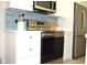 Modern kitchen features stainless steel appliances, white cabinets, and a stylish blue tile backsplash at 140 Spanish Oak Ct. # 1, Surfside Beach, SC 29575