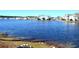 Serene lake view showcasing the calm water and residential buildings in the background at 140 Spanish Oak Ct. # 1, Surfside Beach, SC 29575
