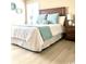 Bright, comfortable bedroom with a nightstand, decorative wall art, and beautiful natural light at 140 Spanish Oak Ct. # 1, Surfside Beach, SC 29575