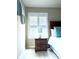 Bright, comfortable bedroom with a nightstand, decorative wall art, and shuttered window at 140 Spanish Oak Ct. # 1, Surfside Beach, SC 29575