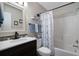 Nautical-themed bathroom featuring a vanity with a black faucet and a shower with a blue and white patterned curtain at 212 Landing Rd. # G, North Myrtle Beach, SC 29582