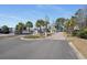 Gated community entrance with palm trees and colorful landscaping at 212 Landing Rd. # G, North Myrtle Beach, SC 29582