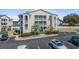 Exterior view of a multi-story condo building with balconies and parking at 212 Landing Rd. # G, North Myrtle Beach, SC 29582