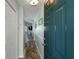 Hallway with wood-look floors leading to an ocean view, with a blue door on the right and access to other rooms at 212 Landing Rd. # G, North Myrtle Beach, SC 29582