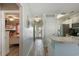 Hallway connects the kitchen and a bedroom, showcasing wood-look floors and a view of the beach through the front door at 212 Landing Rd. # G, North Myrtle Beach, SC 29582