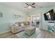 Comfortable living room featuring a beige sofa, patterned ottoman, and access to an outdoor balcony at 212 Landing Rd. # G, North Myrtle Beach, SC 29582