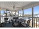 Screened porch offers a ceiling fan, outdoor seating, and relaxing water views at 212 Landing Rd. # G, North Myrtle Beach, SC 29582