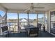 Relaxing screened porch furnished with seating, providing scenic views of the community's waterfront at 212 Landing Rd. # G, North Myrtle Beach, SC 29582