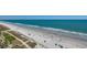 Aerial shot of a sandy beach with people enjoying the sun and sea, showcasing the coastal community at 3000 Ocean Blvd. # 1209, Myrtle Beach, SC 29577